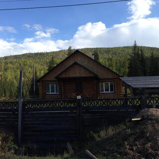 Stacked triangles form the profile of a wooden house.