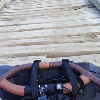 Holes in the cross beams of a wooden bridge.