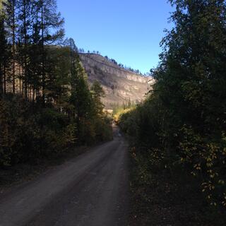 The sun illuminates a hill in the distance.