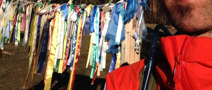 I pose in front of a line of prayer flags.