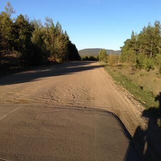 A tar seal road abruptly changes to dirt.