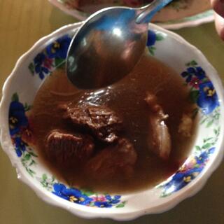 Big chunks of meat in a thin soup.
