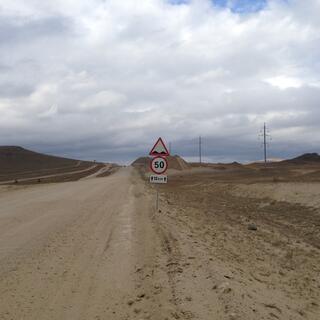 A road sign indicates speed humps.