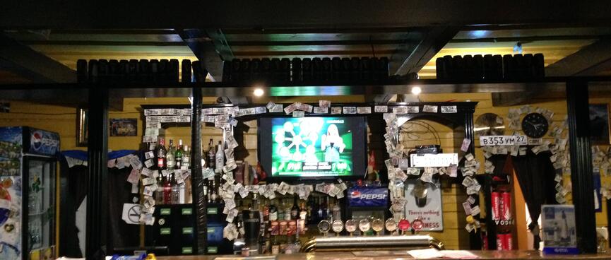 Eight beer taps at a bar.