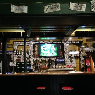 Eight beer taps at a bar.