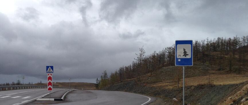 A sign indicates a tree falling towards a chair.