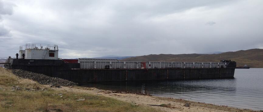 A small container ship is beached.