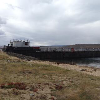 A small container ship is beached.