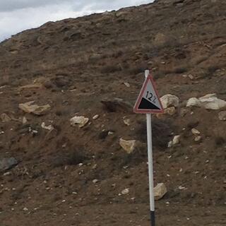 A road sign reads ʼ12%ʼ.