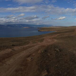 Looking down over green hills to the blue lake.