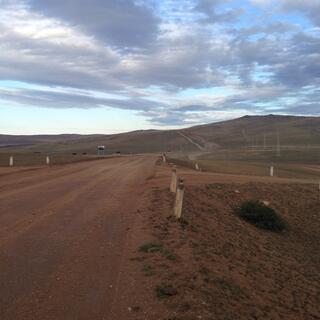 A long road climbs in the distance.