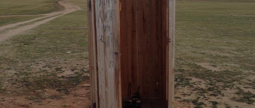 A wooden outhouse.