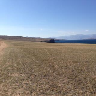 Steppes, cliffs, and the lake below.