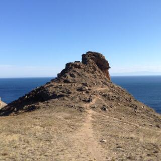 At the crag, the steep track disappears up a rocky path.