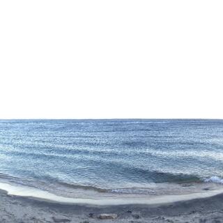 Waves ripple within the sandy bay.