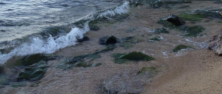 Shards of rock spill into the sea.