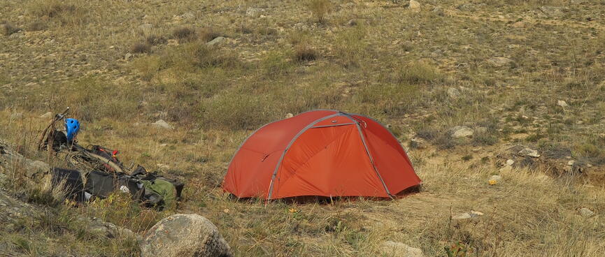The tent and behind it the rocky knoll.