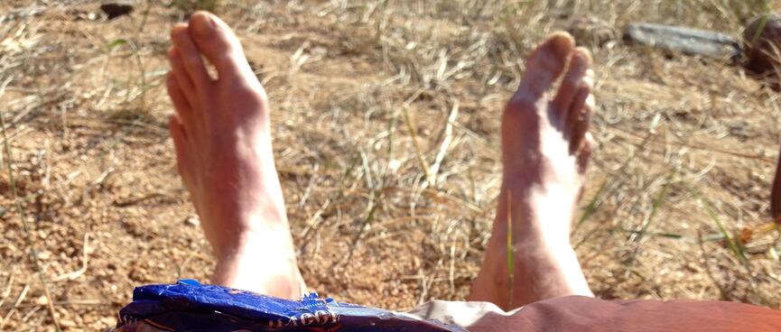My feet in the sun and breakfast food on my sleeping bag.