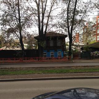A two story house is brown on top and blue on the bottom.