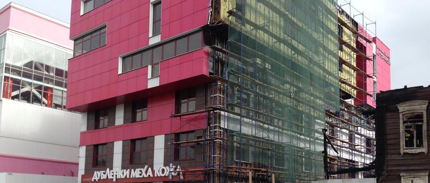 Rectangle windows and pink tiles on a new building.