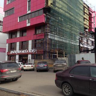 Rectangle windows and pink tiles on a new building.