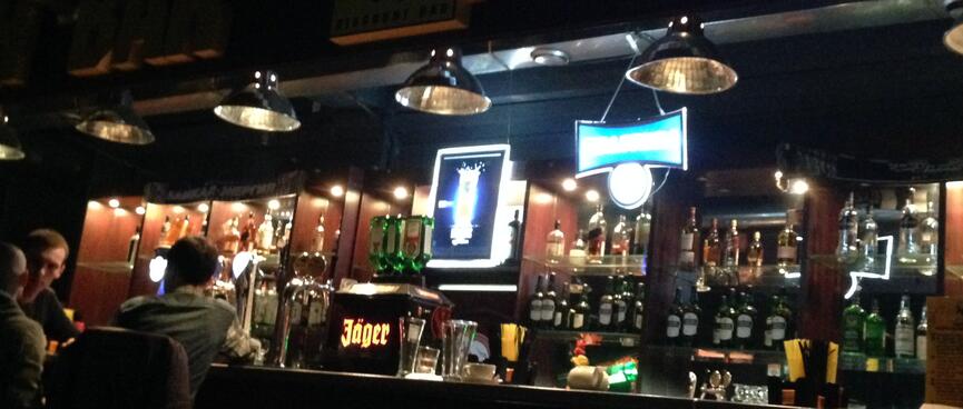Above the bar, Futurama plays on a flatscreen TV.