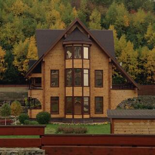 Thirteen windows on the frontage of a three story wooden house.