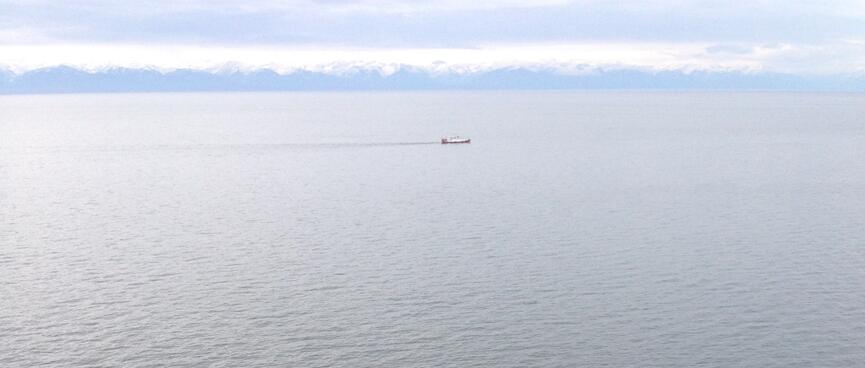 A longer boat leaves a dark trail.