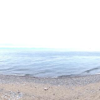 A panorama of the sandy shoreline.