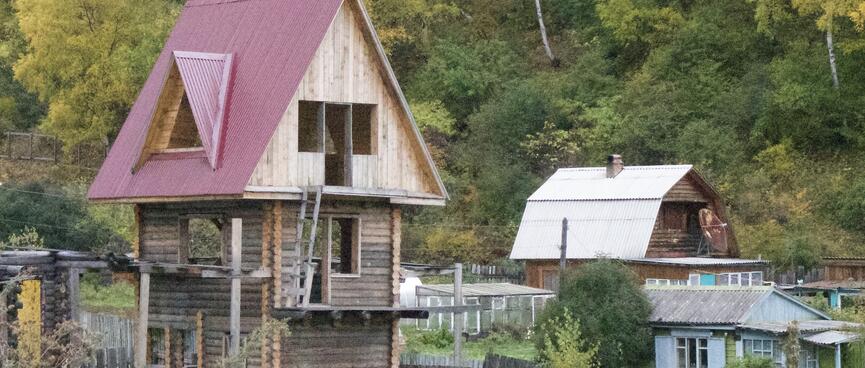 A three story wooden house reminiscent of a childrenʼs tree house.