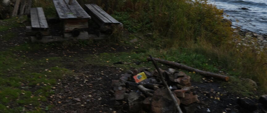 A used fire pit on the lake edge.