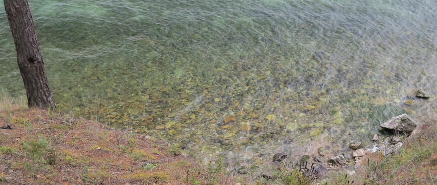 The lake bottom is visible through its clear waters.