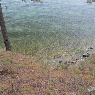The lake bottom is visible through its clear waters.