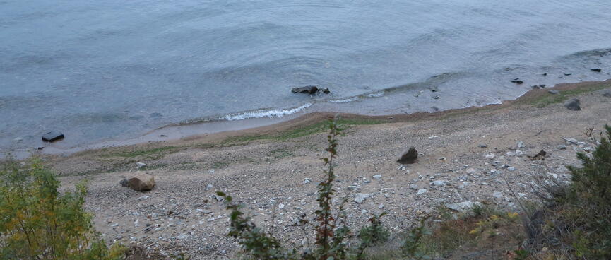 A gentle swell caresses a shallow beach.