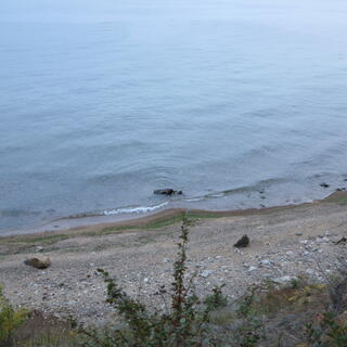 A gentle swell caresses a shallow beach.