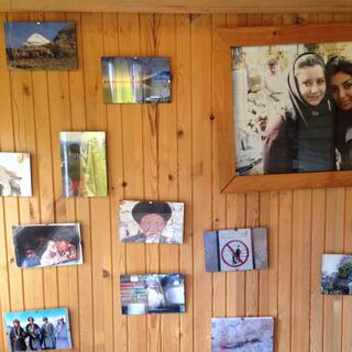 Travel photos on the hostel wall.
