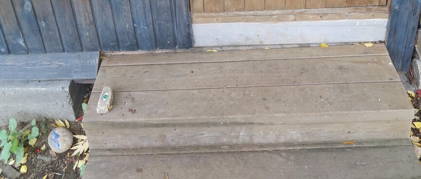 The hostel door, and a doorstop decorated with an eye.