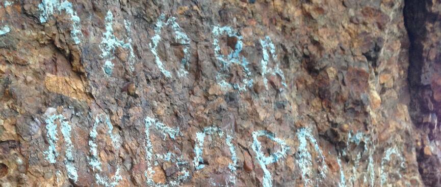 Chalk Cyrillic on the rock wall.