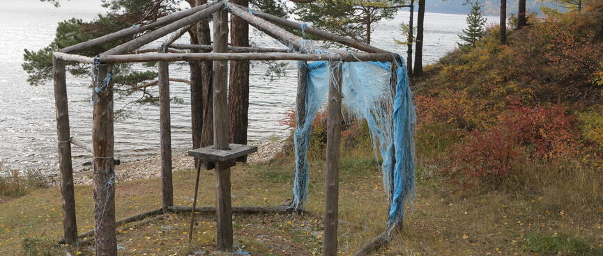 Remnants of plastic netting cling to the side of an open hexagonal structure.
