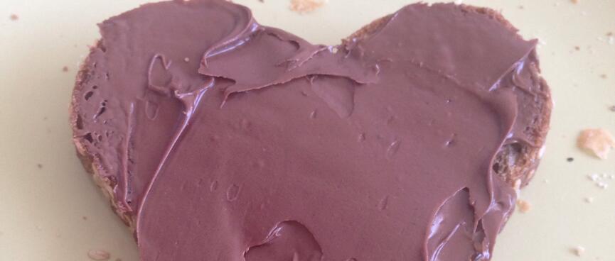 A heart shaped cake with chocolate icing.