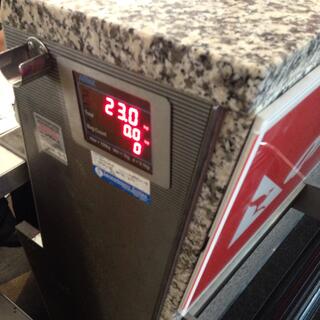The LED readout at the check-in counter reads 23.0kg.