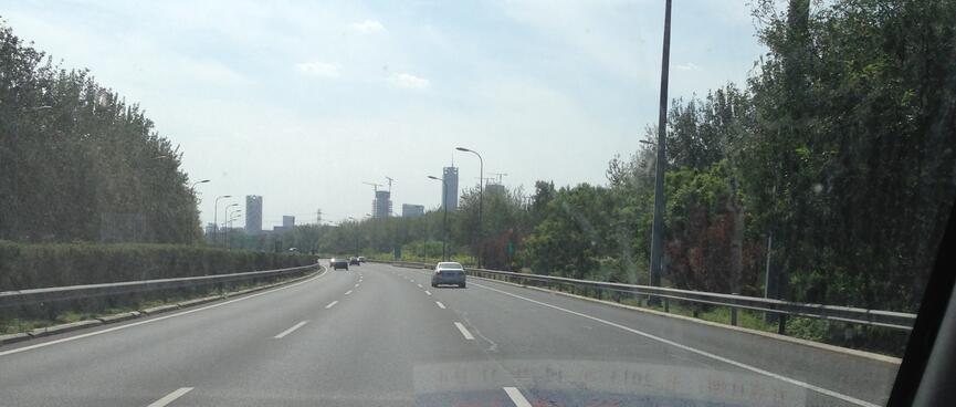 Driving down the three lane expressway towards Beijing city.