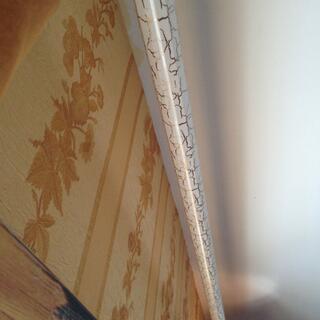 A curtain rail is painted with designer cracks.