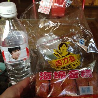 A bottle of water and a packet of sweet breads.