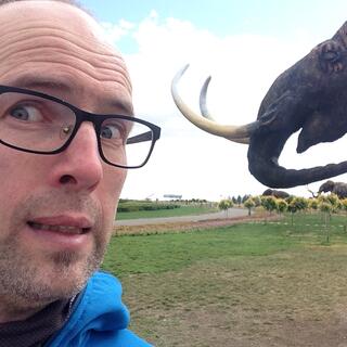 A mammothʼs sharp tusks are only inches away from my pale face.
