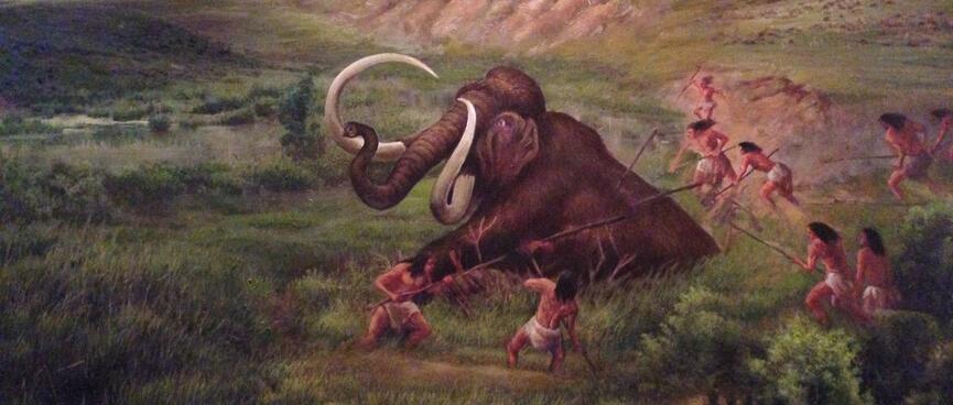A painting shows locals spearing and lassoing an injured mammoth.