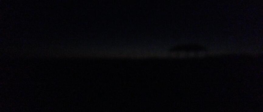 As night falls, the horizon is only barely visible.