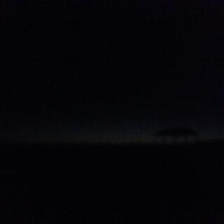 As night falls, the horizon is only barely visible.