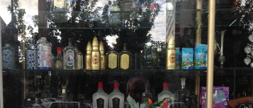 Ornate vases and bullet-shaped vodka bottles in a shop window.