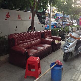 The footpath is filled with motorcycles and Shabby Chic leather couches.